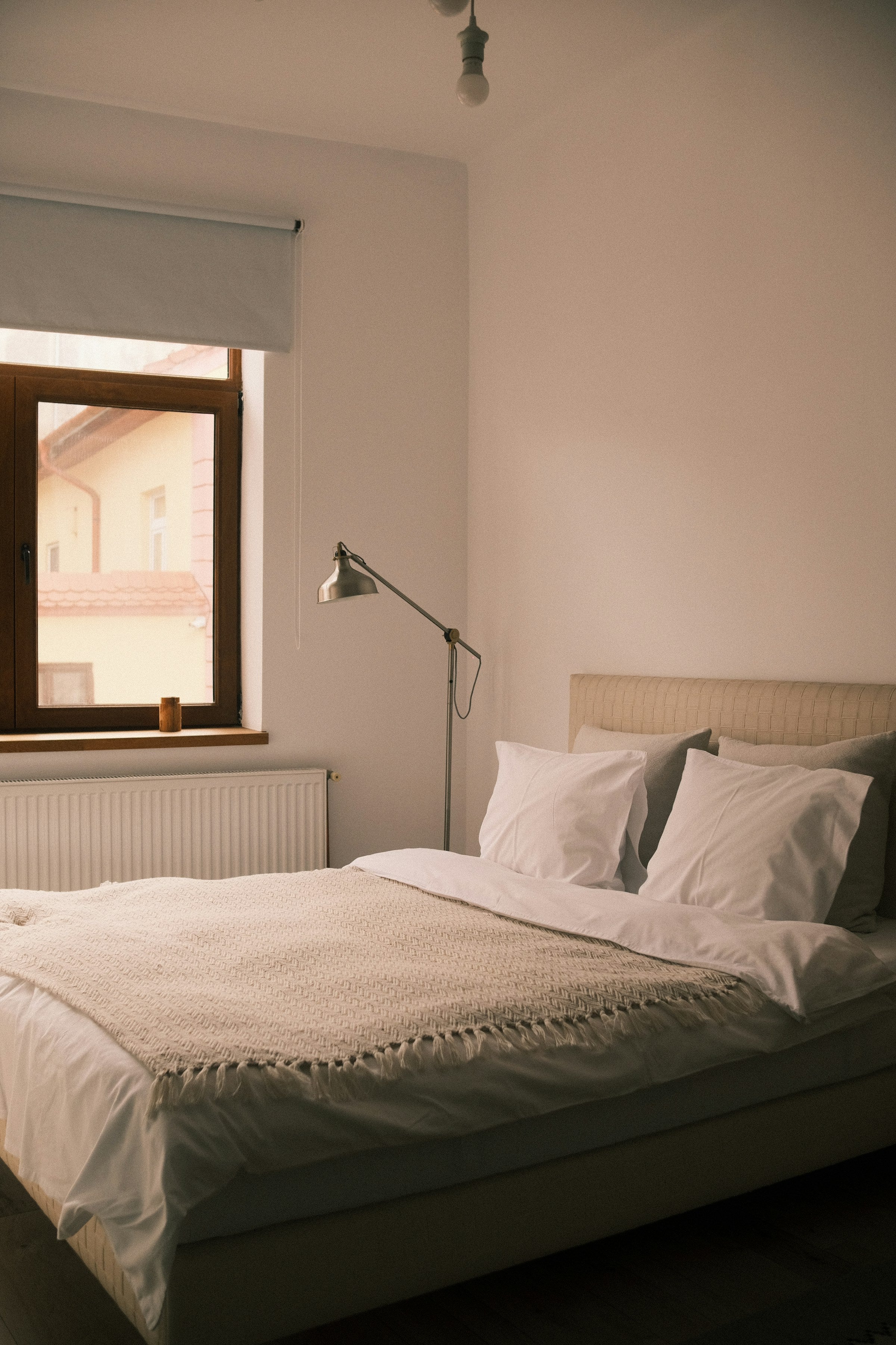 Sunlit bedroom with soft natural linen bedding